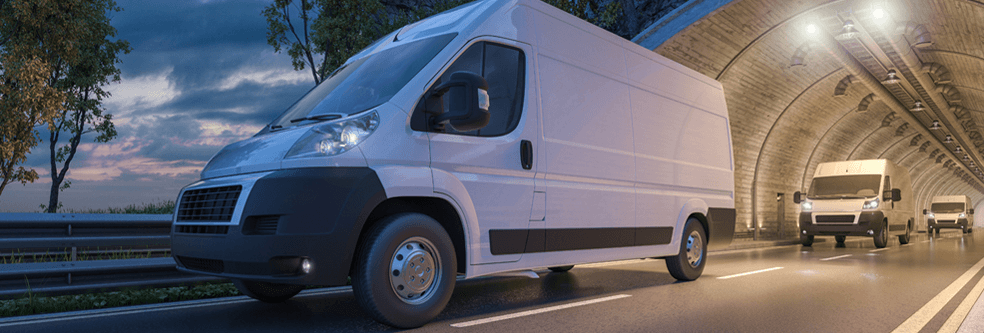 a fleet of vans driving through a tunnel