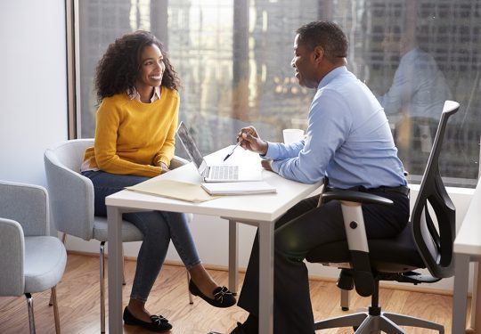 Woman meeting with male insurance agent in office